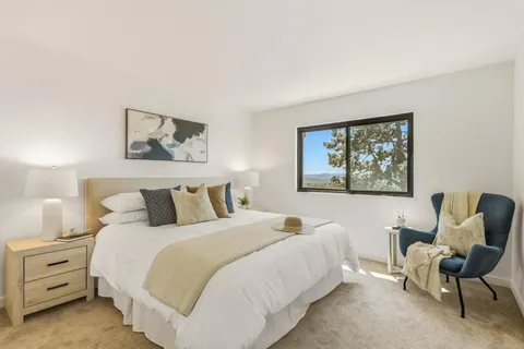 a bedroom with a bed and chair