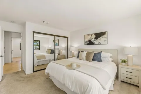 a bedroom with a bed and a large mirror