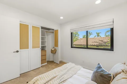 a bedroom with a bed and wall painting