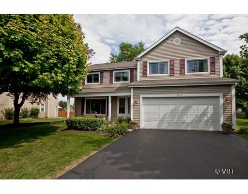 1118 Country Ridge Lane Bolingbrook, IL 60440 - Photo 1 of 16 a front view of a house with a garden and yard