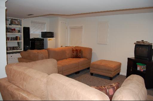 1118 Country Ridge Lane Bolingbrook, IL 60440 - Photo 14 of 16 a living room with furniture and a flat screen tv