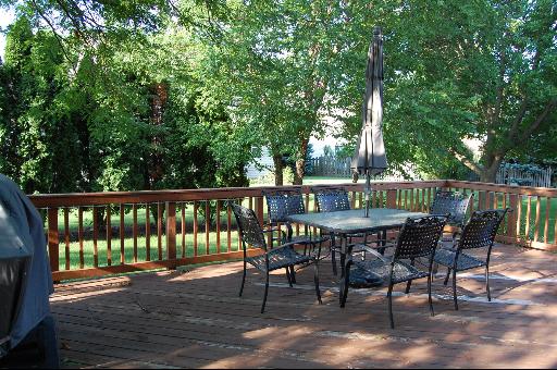 1118 Country Ridge Lane Bolingbrook, IL 60440 - Photo 15 of 16 a view of a roof deck with table and chairs and wooden floor