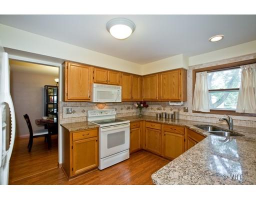 1118 Country Ridge Lane Bolingbrook, IL 60440 - Photo 3 of 16 a kitchen with stainless steel appliances granite countertop a stove a sink and a microwave