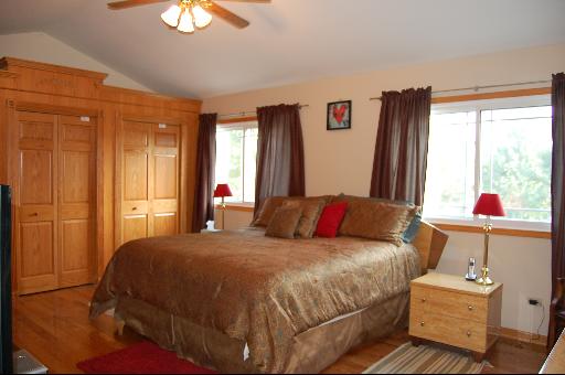 1118 Country Ridge Lane Bolingbrook, IL 60440 - Photo 8 of 16 a bedroom with a bed and a chandelier