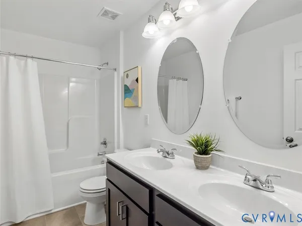 a bathroom with a granite countertop sink a toilet and a mirror