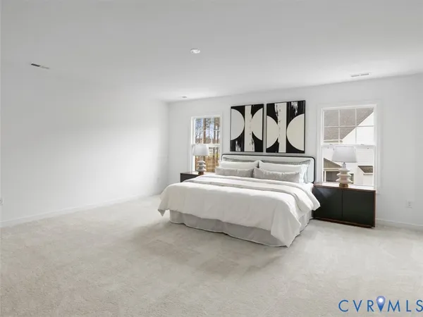 a bedroom with a bed and a painting on the wall