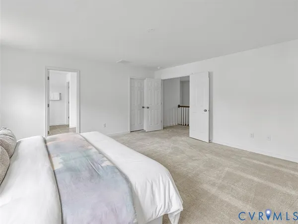 a spacious bedroom with a bed and a cabinets