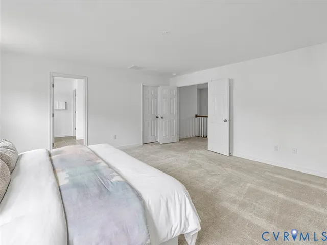 a spacious bedroom with a bed and a cabinets