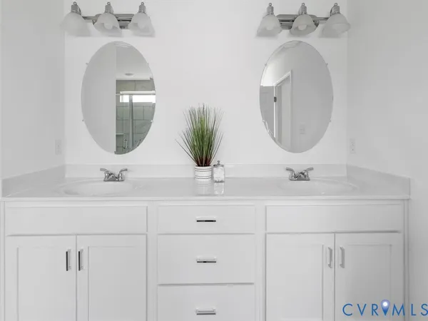 a bathroom with a double vanity sink and a mirror