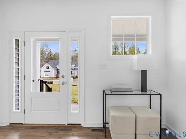 a view of an entryway with wooden floor