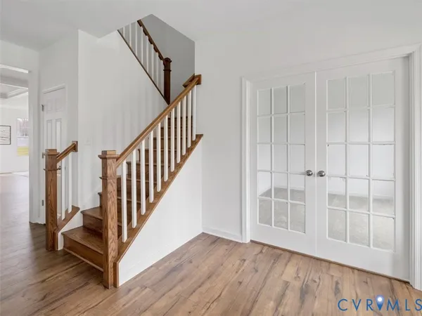 a view of front door with wooden floor and stairs