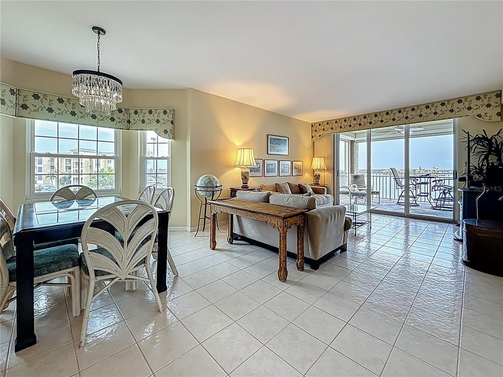 399 150th Avenue, Unit 317 Madeira Beach, FL 33708 - Photo 11 of 96 a living room with furniture chandelier and a chandelier