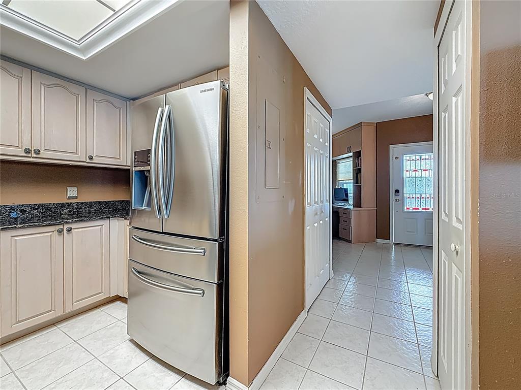 399 150th Avenue, Unit 317 Madeira Beach, FL 33708 - Photo 20 of 96 a kitchen with stainless steel appliances granite countertop a refrigerator and a stove top oven