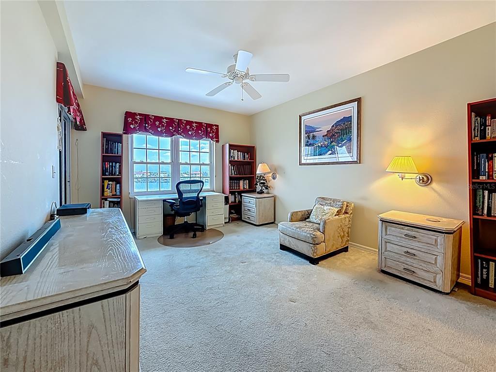 399 150th Avenue, Unit 317 Madeira Beach, FL 33708 - Photo 23 of 96 a living room with furniture and a chandelier