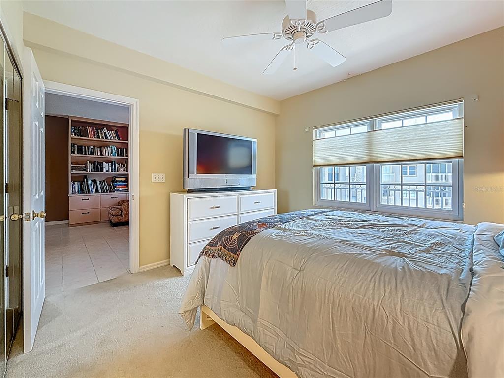 399 150th Avenue, Unit 317 Madeira Beach, FL 33708 - Photo 28 of 96 a bedroom with a bed and a flat screen tv