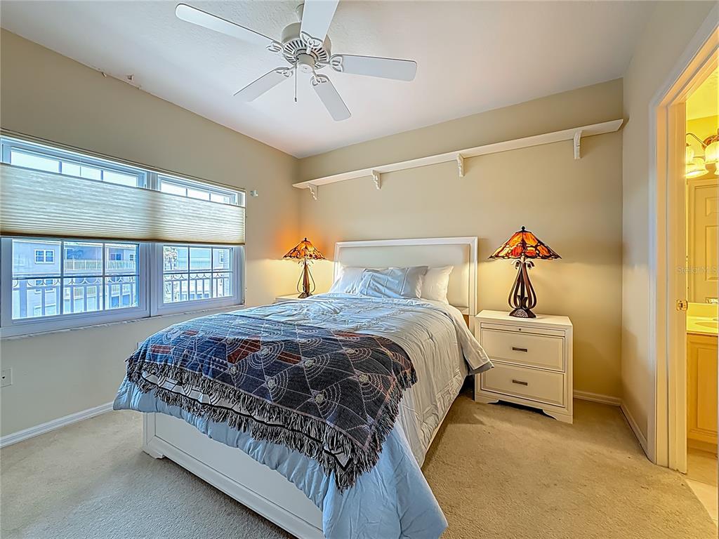 399 150th Avenue, Unit 317 Madeira Beach, FL 33708 - Photo 30 of 96 a bedroom with a bed and a window