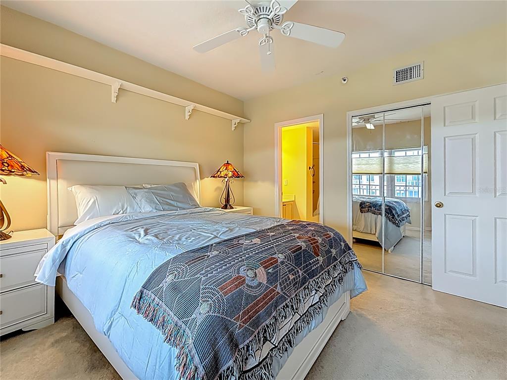 399 150th Avenue, Unit 317 Madeira Beach, FL 33708 - Photo 32 of 96 a bedroom with a bed and a window