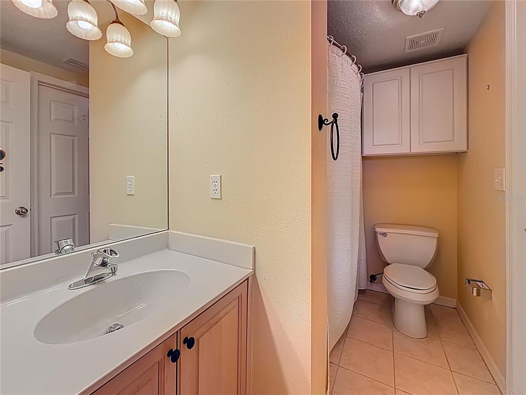 399 150th Avenue, Unit 317 Madeira Beach, FL 33708 - Photo 34 of 96 a bathroom with a sink a toilet and a mirror