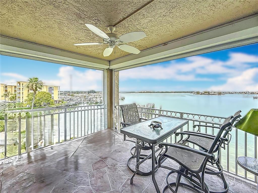 399 150th Avenue, Unit 317 Madeira Beach, FL 33708 - Photo 6 of 96 a view of a balcony with furniture and window