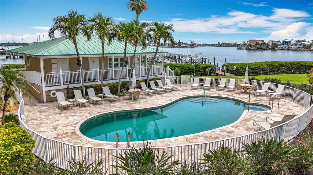 399 150th Avenue, Unit 317 Madeira Beach, FL 33708 - Photo 61 of 96 a view of a swimming pool with a patio