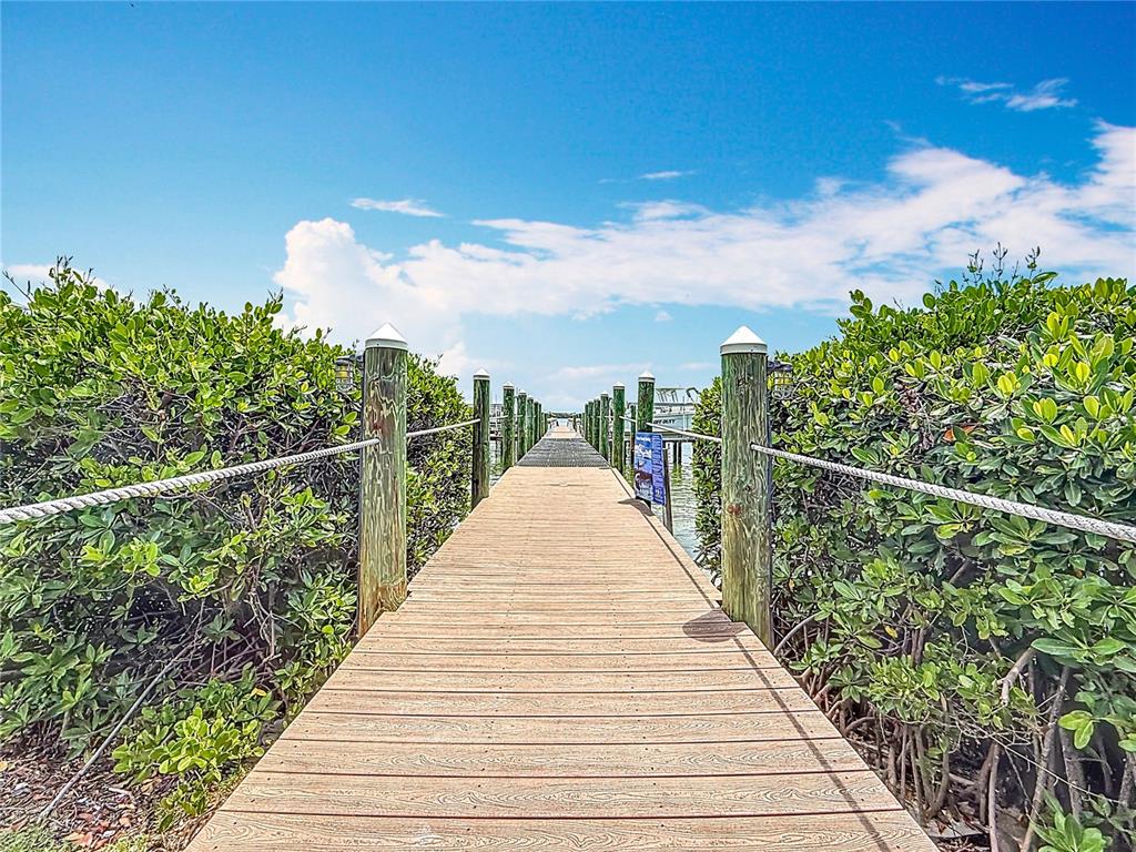 399 150th Avenue, Unit 317 Madeira Beach, FL 33708 - Photo 64 of 96 a view of a balcony with wooden floor and fence