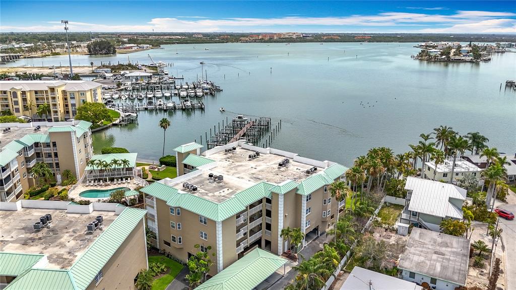 399 150th Avenue, Unit 317 Madeira Beach, FL 33708 - Photo 76 of 96 a view of a terrace with a table and chairs