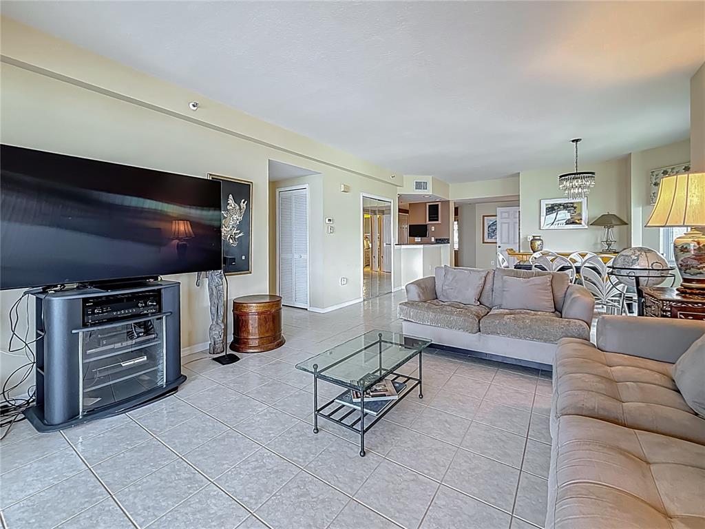 399 150th Avenue, Unit 317 Madeira Beach, FL 33708 - Photo 10 of 96 a living room with furniture and a flat screen tv