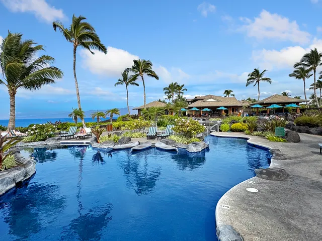 a view of a swimming pool with furniture