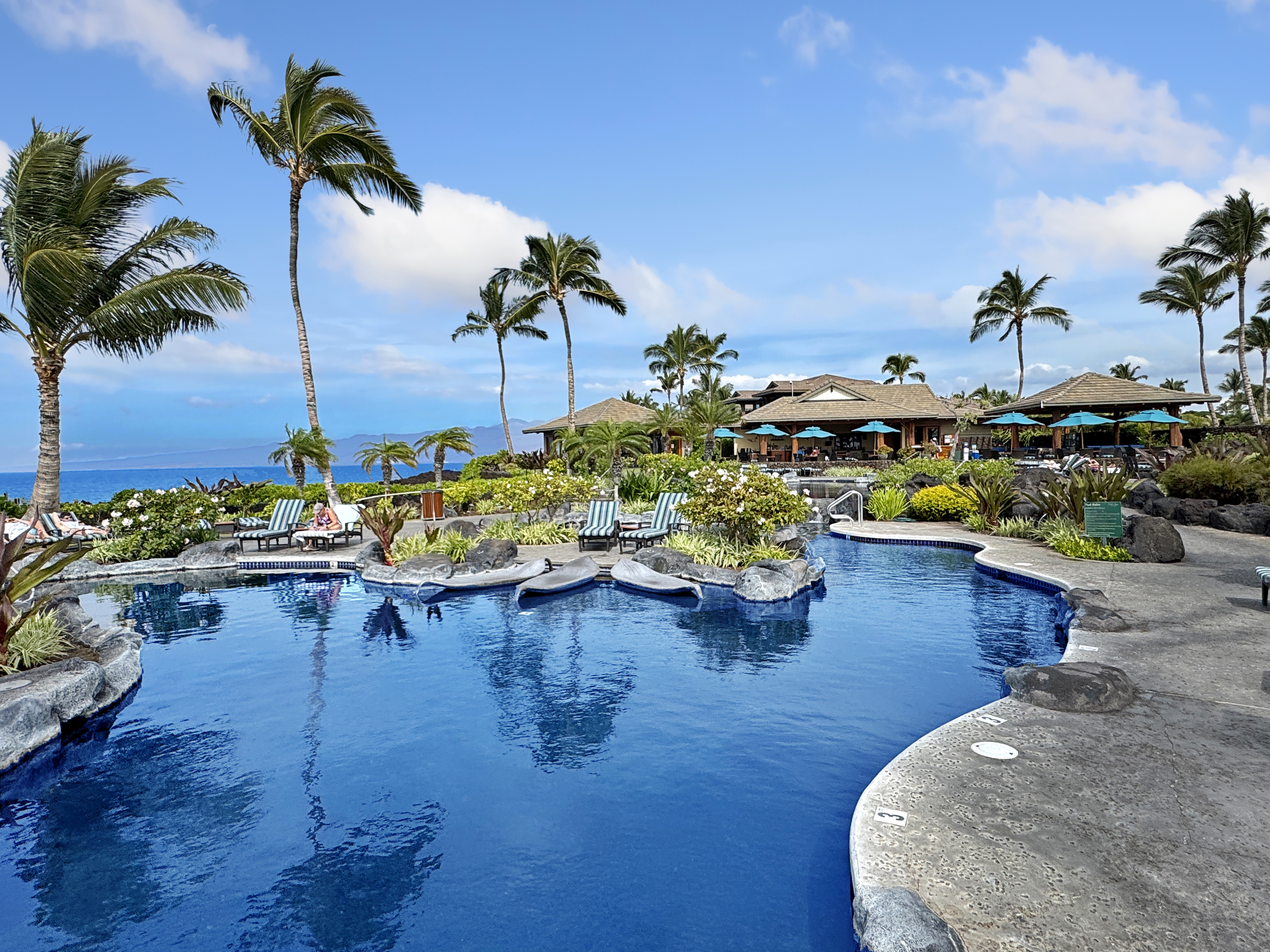 a view of a swimming pool with furniture