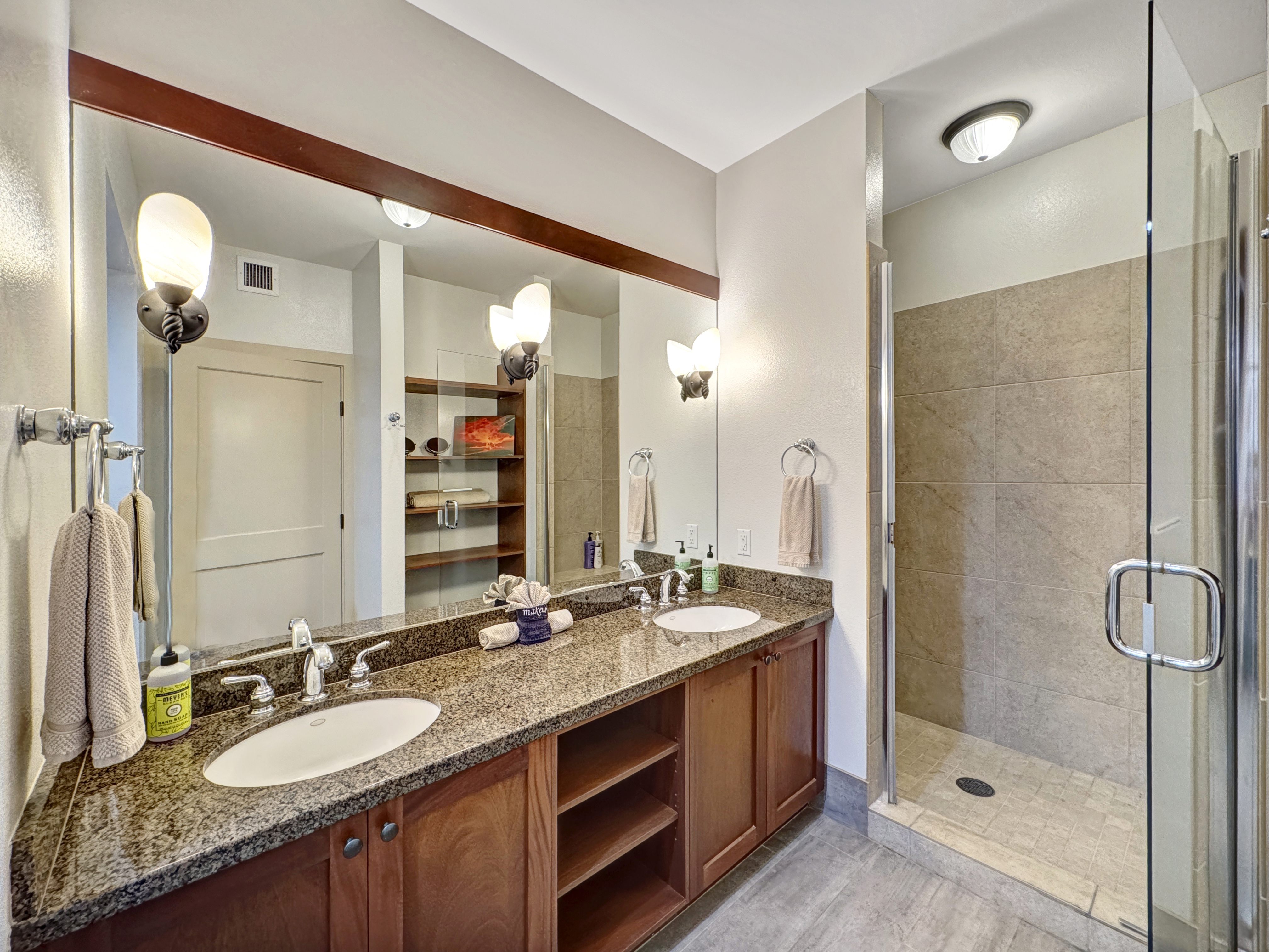 69-1033 Nawahine Place, Unit 9B Waikoloa, HI 96738 - Photo 11 of 24 a bathroom with a granite countertop double vanity sink and a mirror