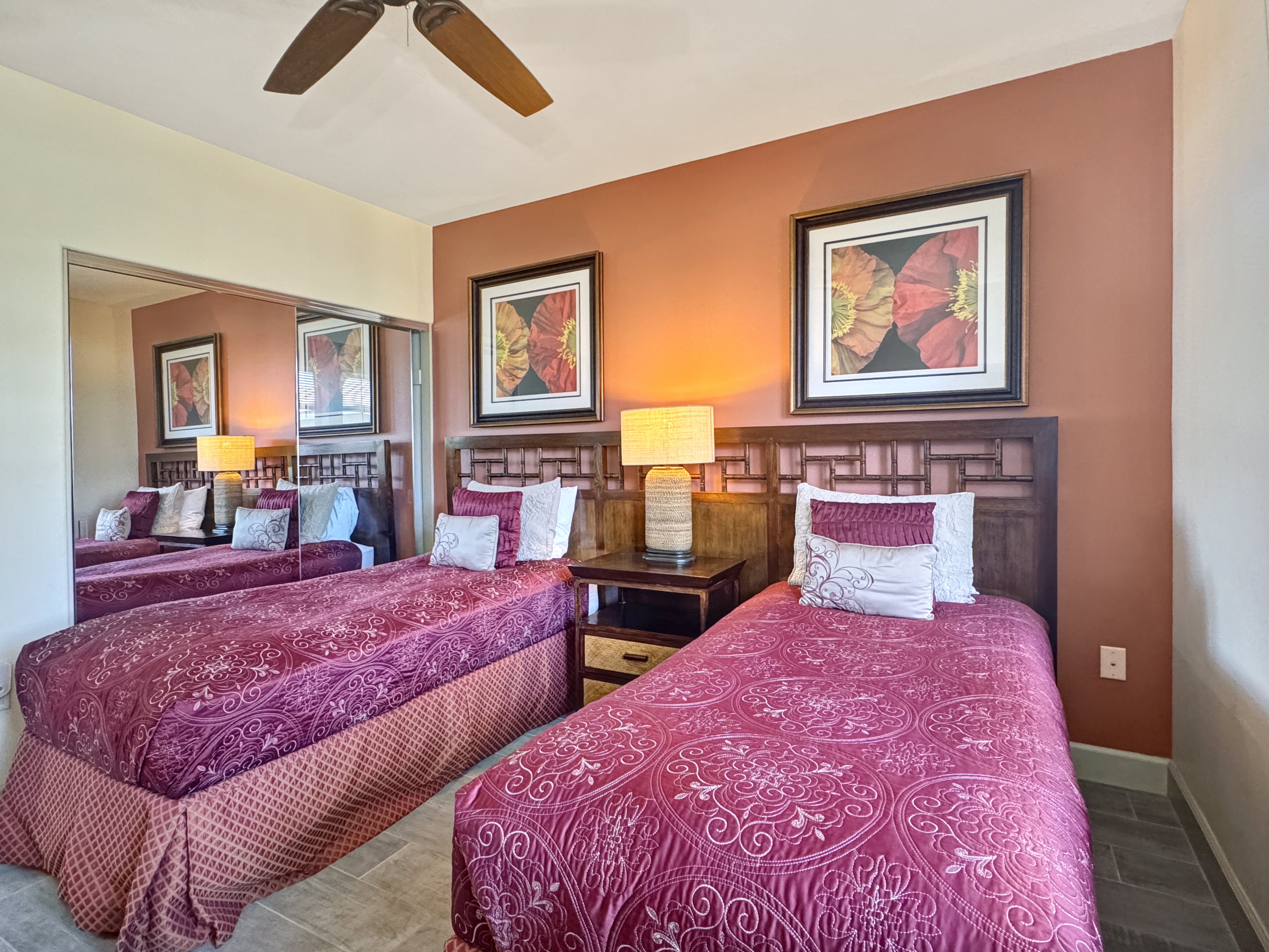 69-1033 Nawahine Place, Unit 9B Waikoloa, HI 96738 - Photo 13 of 24 a bedroom with two beds and a large mirror on dresser