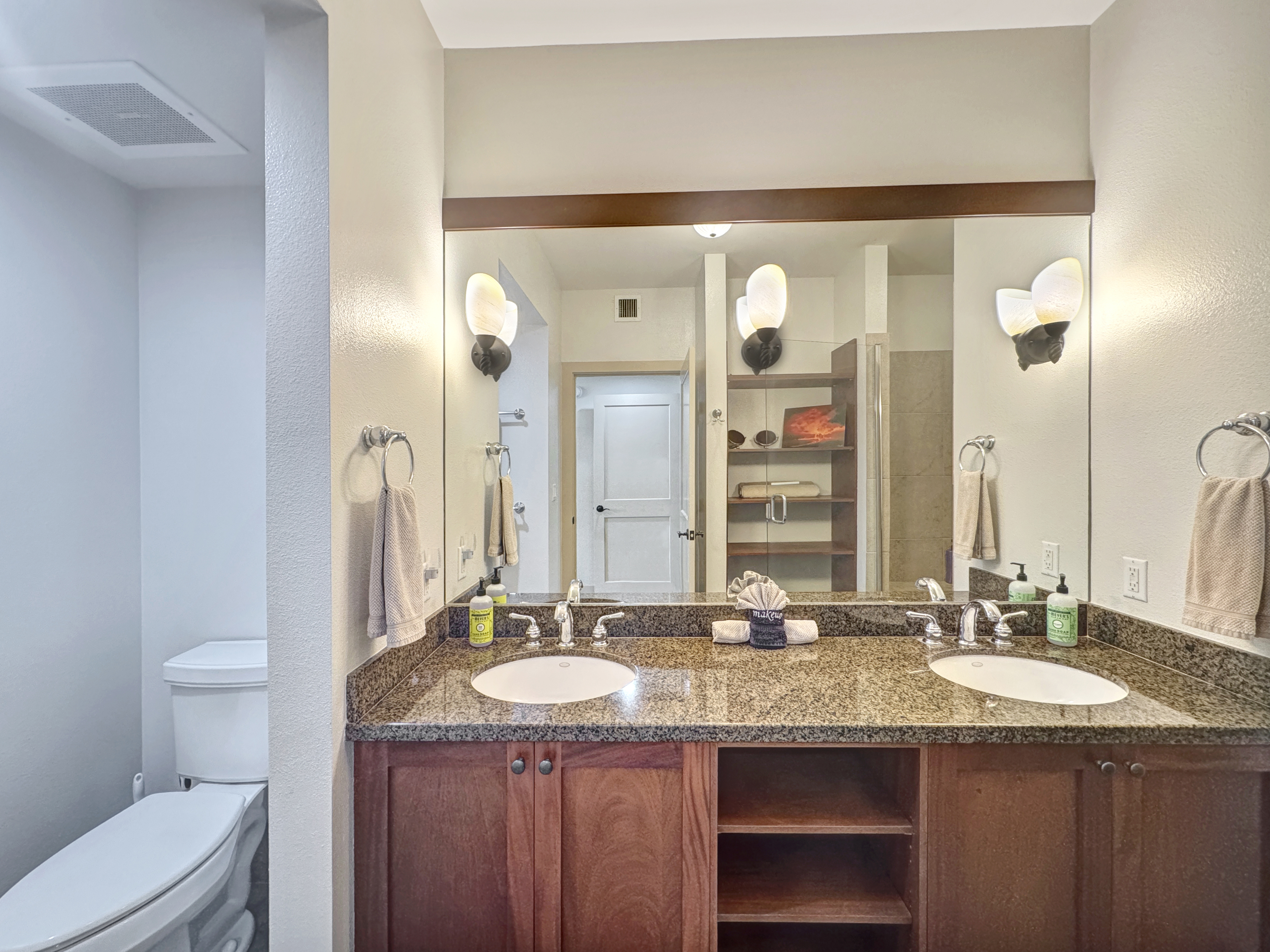 69-1033 Nawahine Place, Unit 9B Waikoloa, HI 96738 - Photo 10 of 24 a bathroom with a granite countertop sink and a mirror