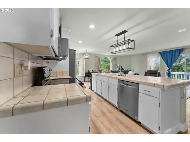 a kitchen with a sink appliances and cabinets