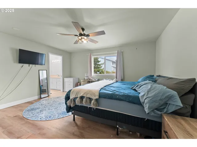 a bedroom with a bed a chandelier and a mirror