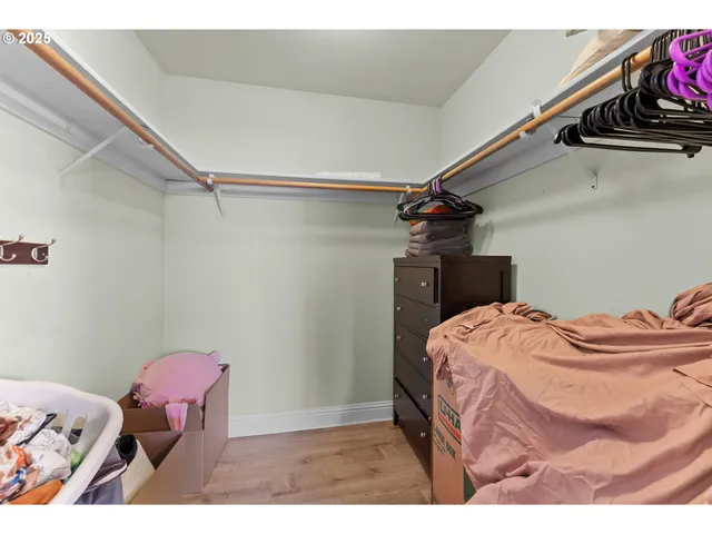 a bedroom with a bed and a chair