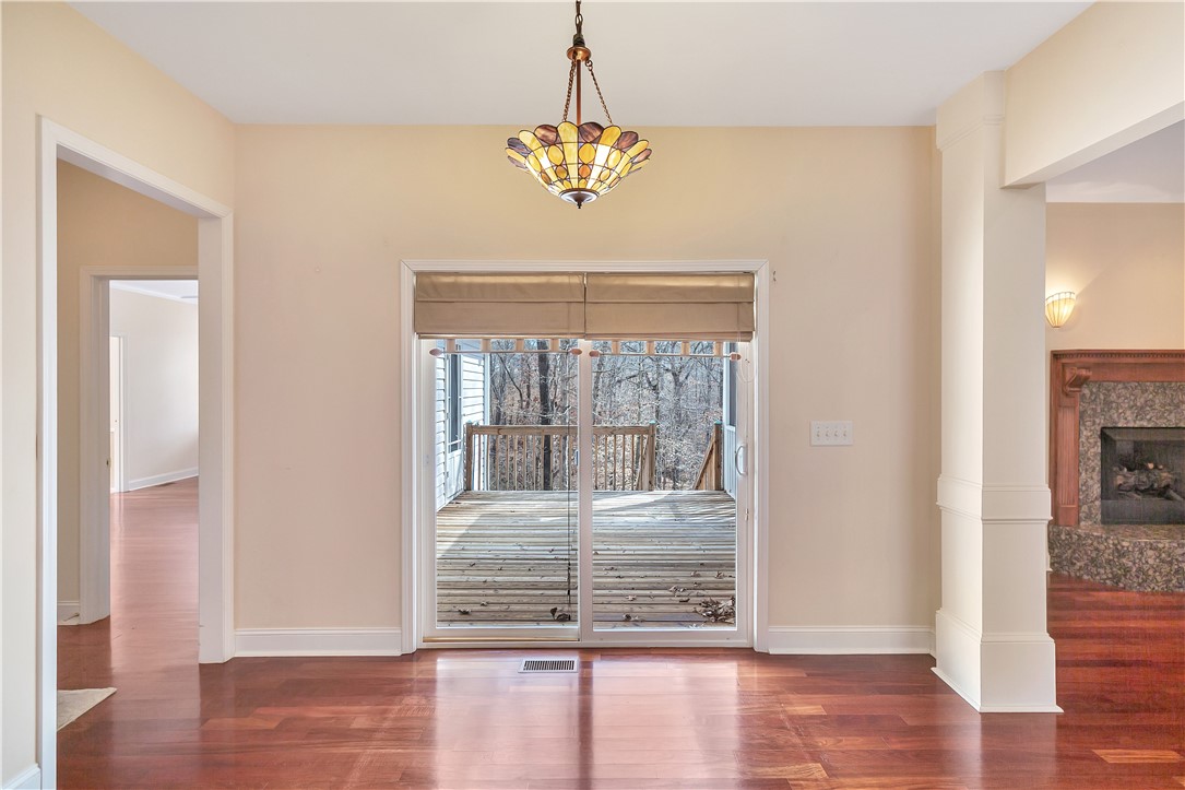 1432 Hunters Trail Anderson, SC 29625 - Photo 11 of 35 This interior space features rich hardwood flooring and a sliding glass door leading to an outdoor deck.
