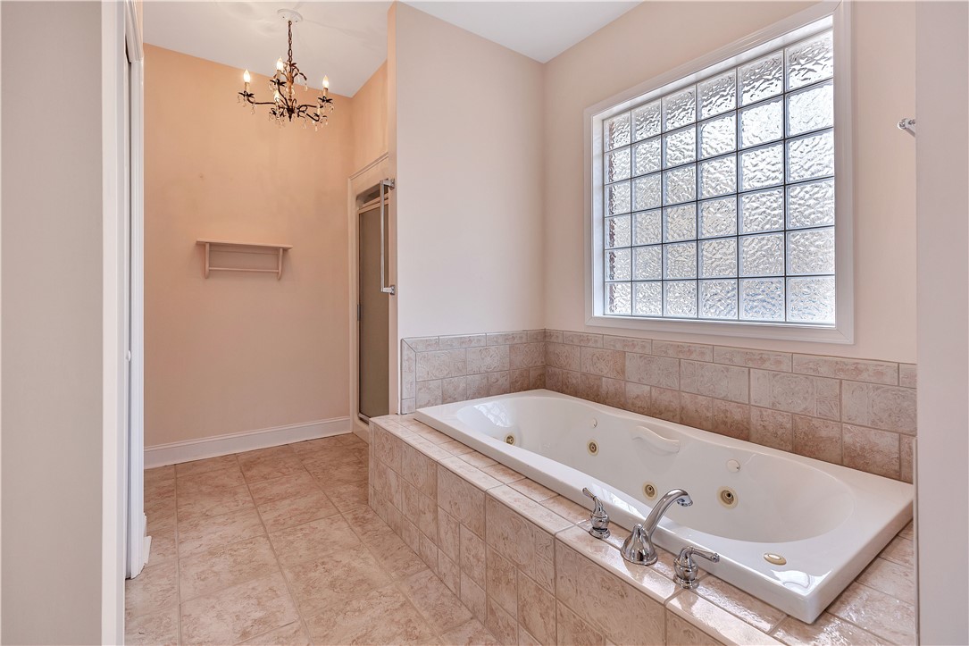1432 Hunters Trail Anderson, SC 29625 - Photo 16 of 35 Relax in the deep soaking tub in this light-filled bathroom.