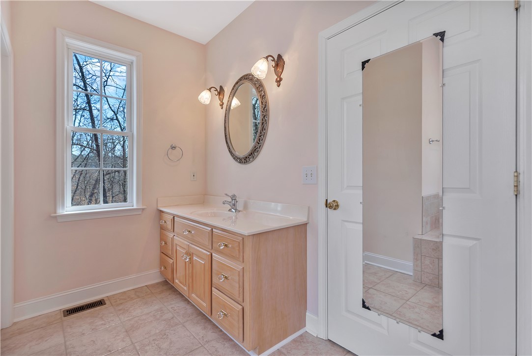 1432 Hunters Trail Anderson, SC 29625 - Photo 17 of 35 Bright bathroom with a single vanity and a large window offering natural views.