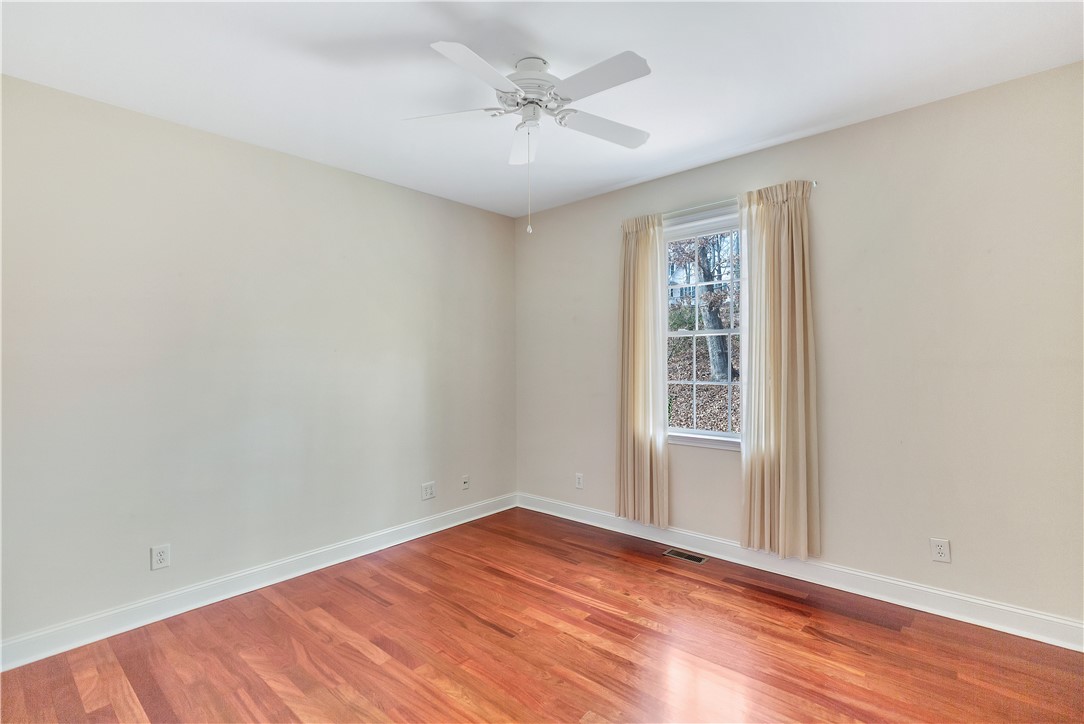 1432 Hunters Trail Anderson, SC 29625 - Photo 19 of 35 This airy room features rich hardwood flooring and a bright window, creating a serene atmosphere.