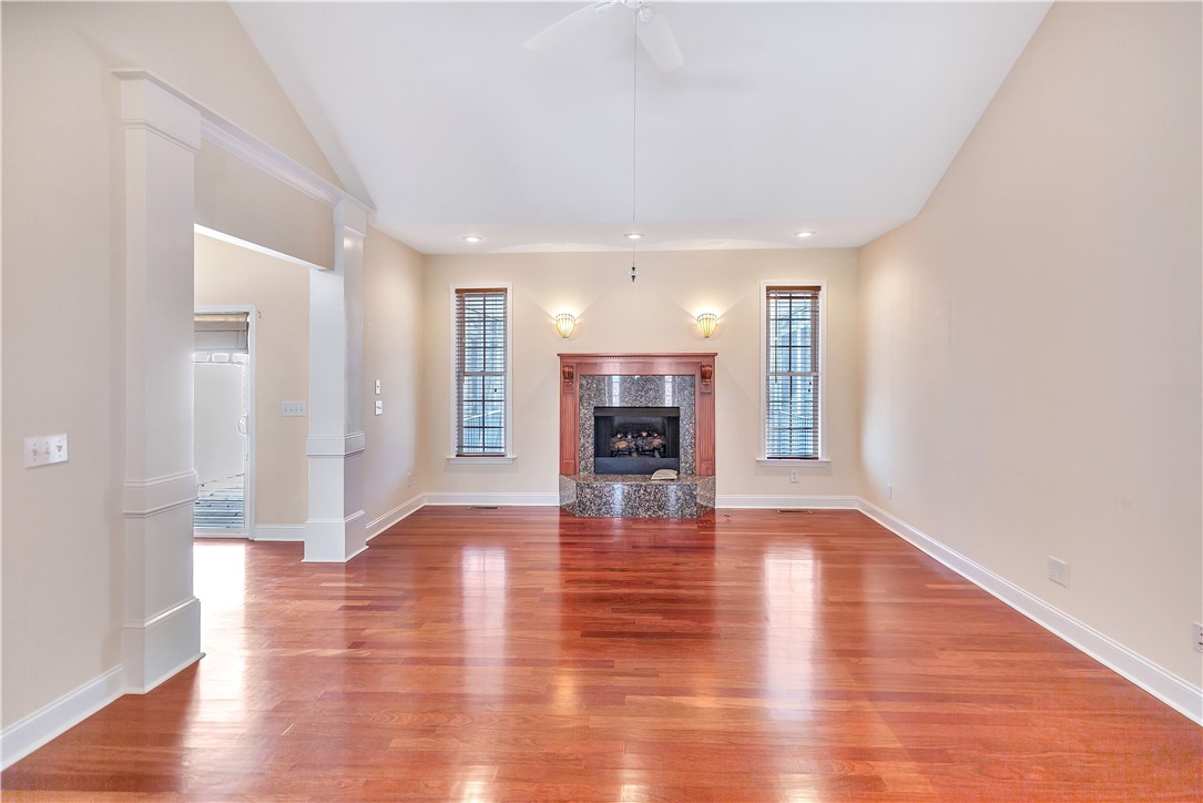 1432 Hunters Trail Anderson, SC 29625 - Photo 5 of 35 This living area features gleaming hardwood floors and a striking fireplace, creating a warm, inviting atmosphere.