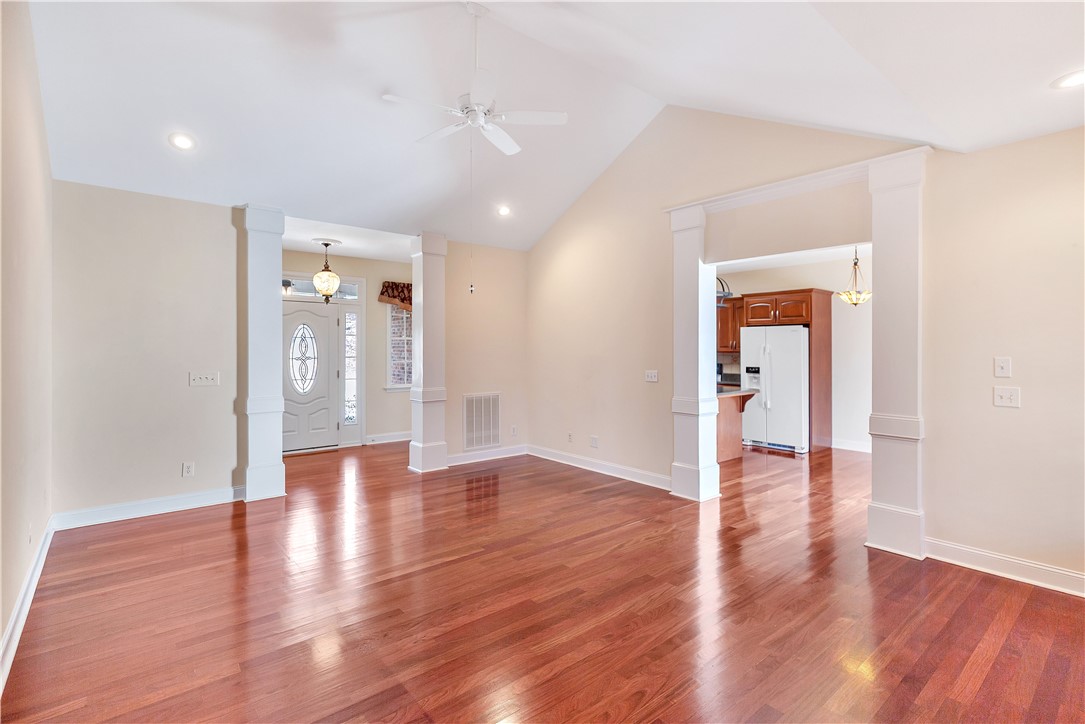 1432 Hunters Trail Anderson, SC 29625 - Photo 6 of 35 This inviting space features lustrous wood flooring and vaulted ceilings, perfect for comfortable living.