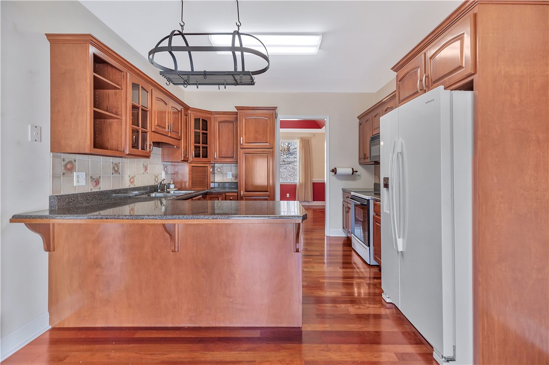 1432 Hunters Trail Anderson, SC 29625 - Photo 9 of 35 This spacious kitchen offers a large island, generous cabinetry, and durable hardwood flooring.