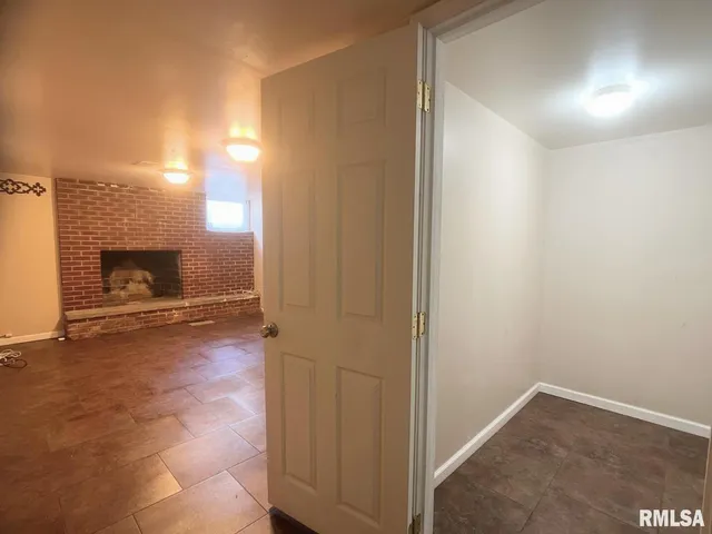 a view of an empty room and fire place