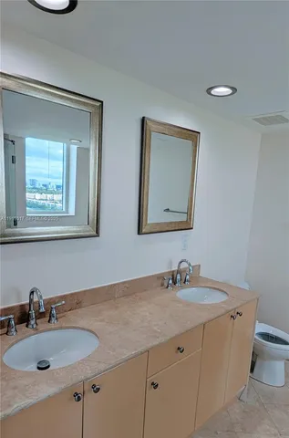 an empty room that has a chandelier fan and window