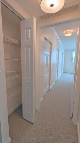 a vase of flowers sitting on a floor