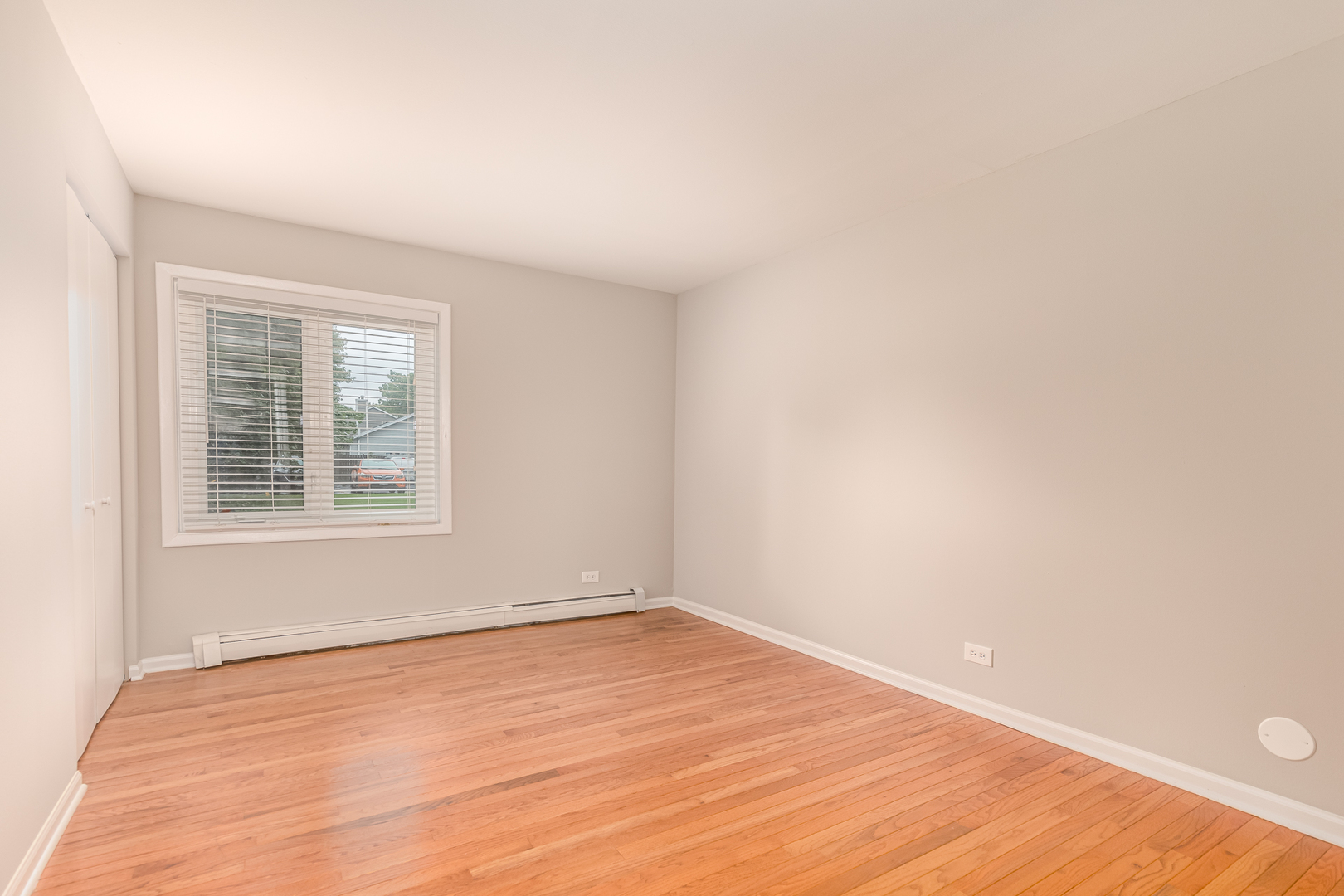850 South Lorraine Road, Unit 1J Wheaton, IL 60189 - Photo 12 of 22 a view of an empty room with wooden floor and a window