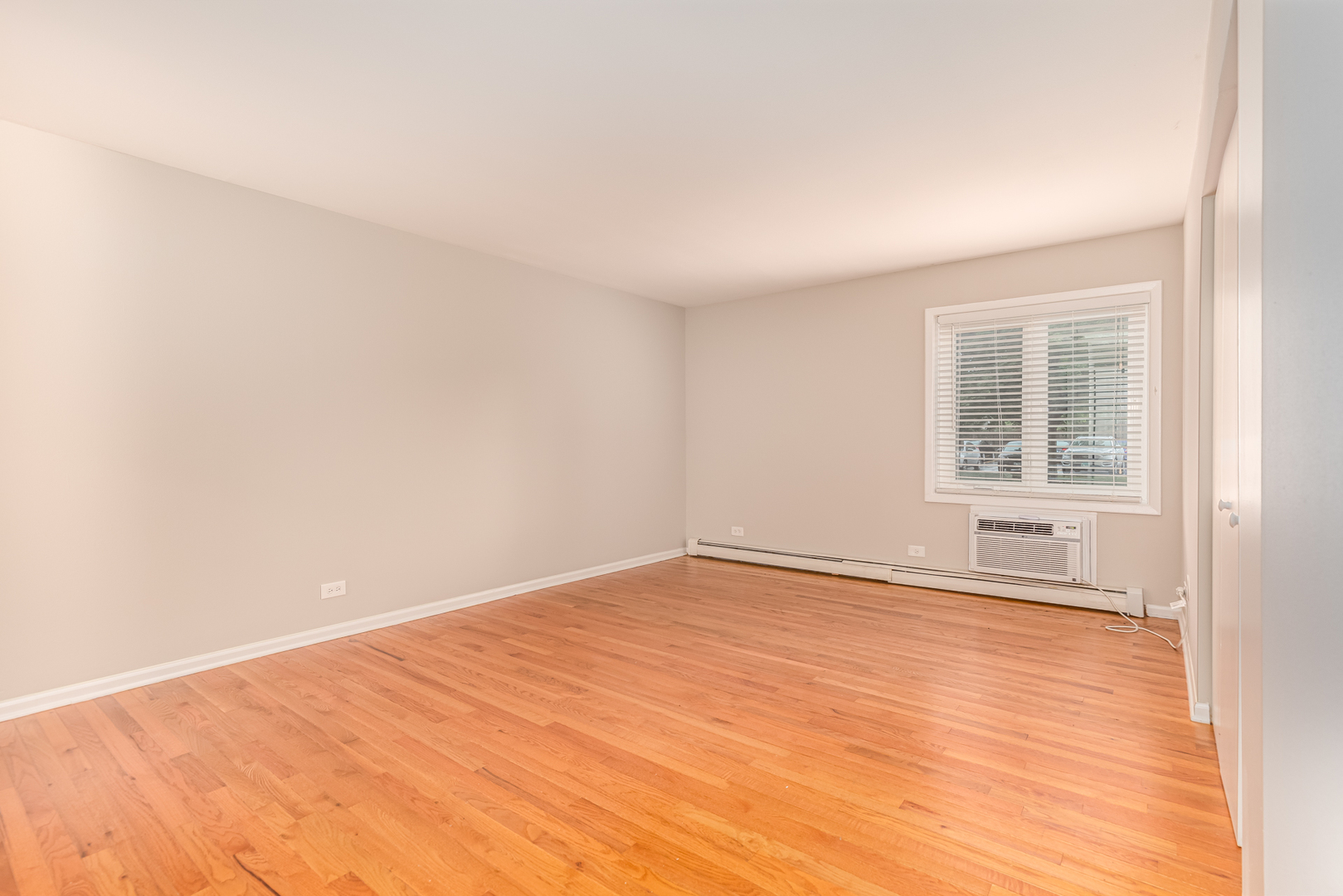 850 South Lorraine Road, Unit 1J Wheaton, IL 60189 - Photo 14 of 22 an empty room with wooden floor and windows