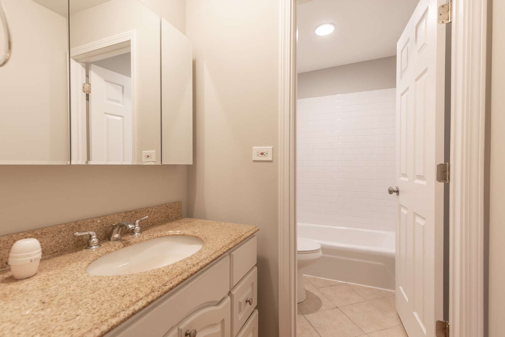 850 South Lorraine Road, Unit 1J Wheaton, IL 60189 - Photo 16 of 22 a bathroom with a granite countertop sink and a mirror