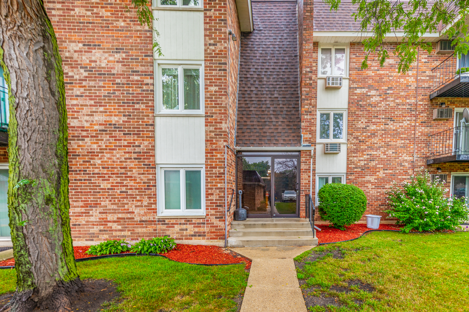 850 South Lorraine Road, Unit 1J Wheaton, IL 60189 - Photo 3 of 22 a front view of a house with garden and porch