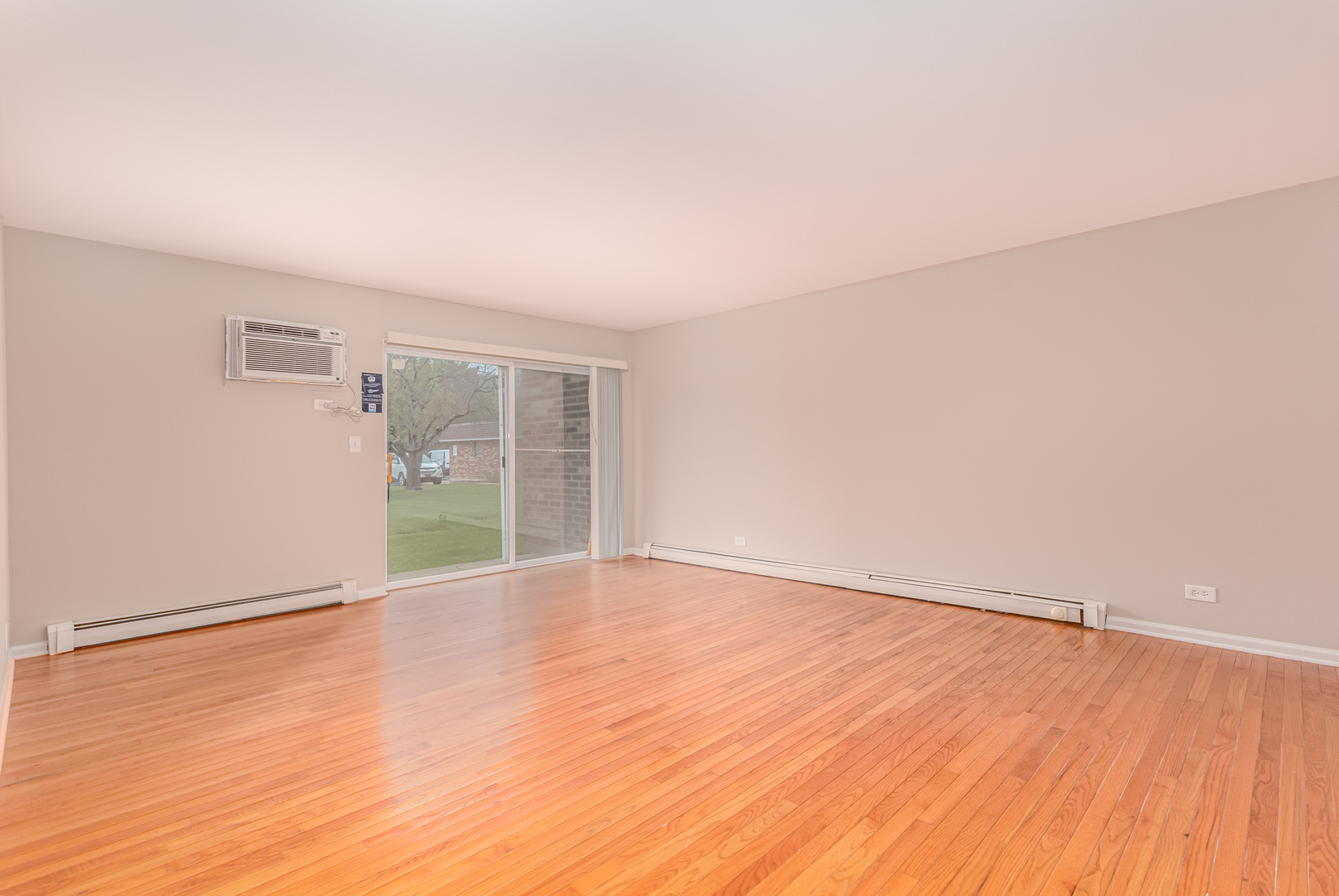 850 South Lorraine Road, Unit 1J Wheaton, IL 60189 - Photo 9 of 22 a view of an empty room with wooden floor and a window